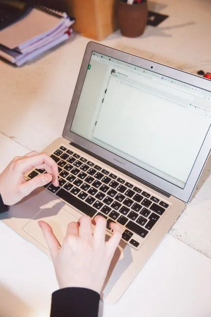 Person analyzing cryptocurrency data using a laptop, highlighting financial insights.